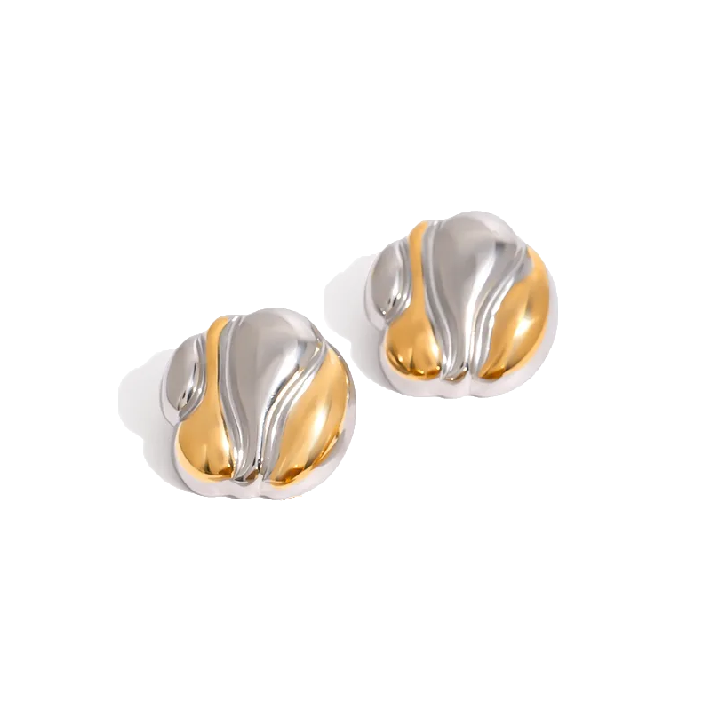 Bold, gold- and silver-coloured statement earrings with fluid, sculptural curves inspired by organic forms; elegant and romantic with a glossy finish, reflecting Hopeless Romantic Society’s sensual, poetic aesthetic
